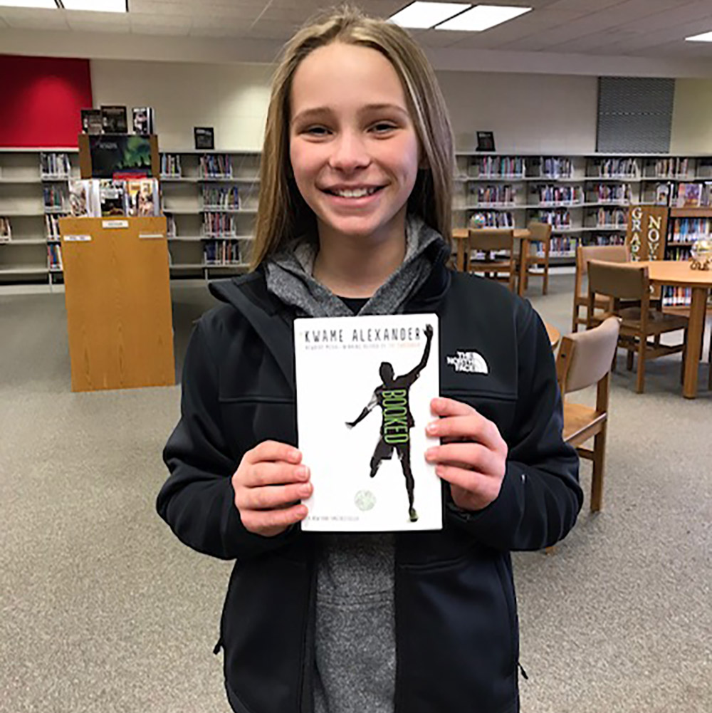 student holding book