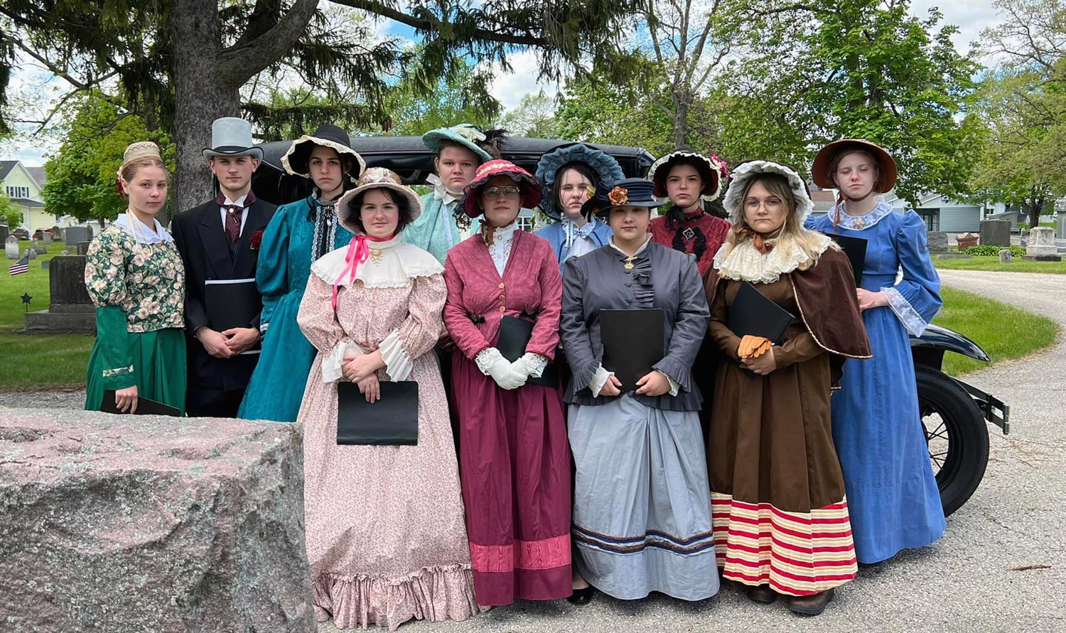 Students in period costume at cemetery
