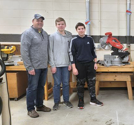 donor and students with saw