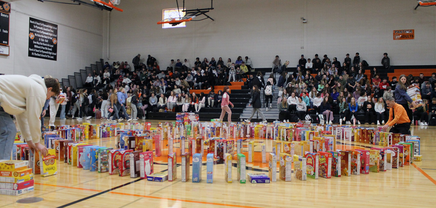 Organizers line up cereal boxes in gym