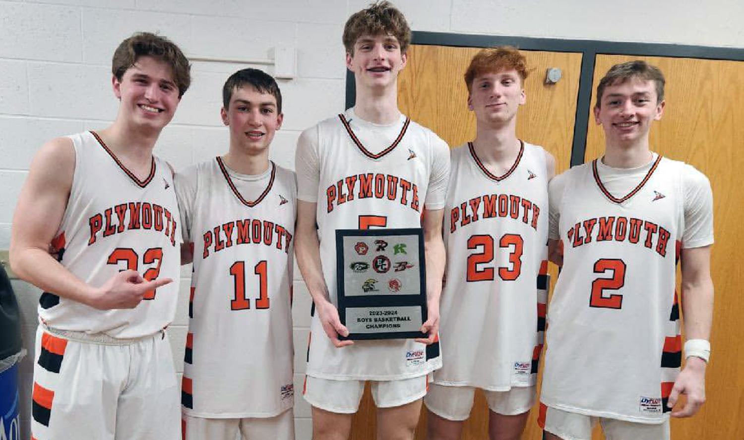 PHS Boys Basketball seniors with conference plaque