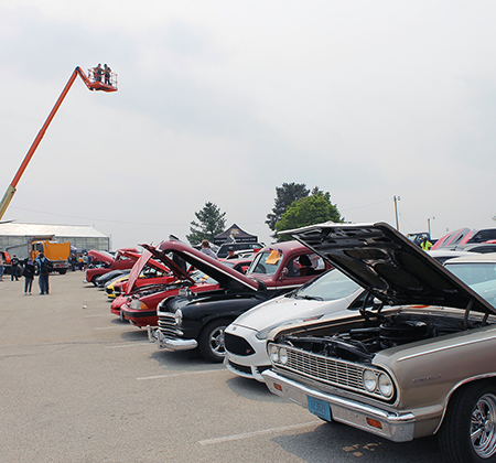people looking at cars