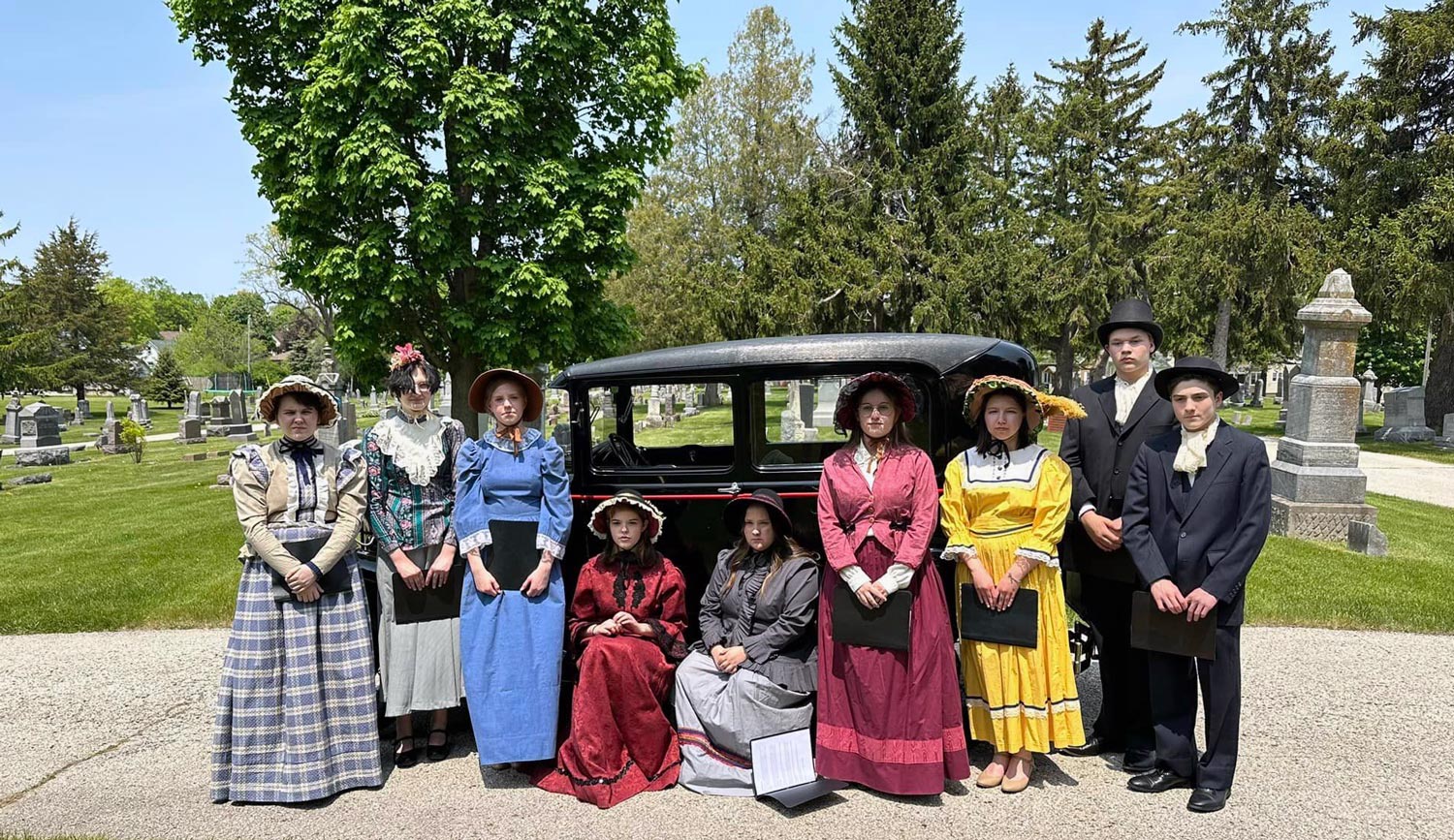 Students in period costume at cemetery