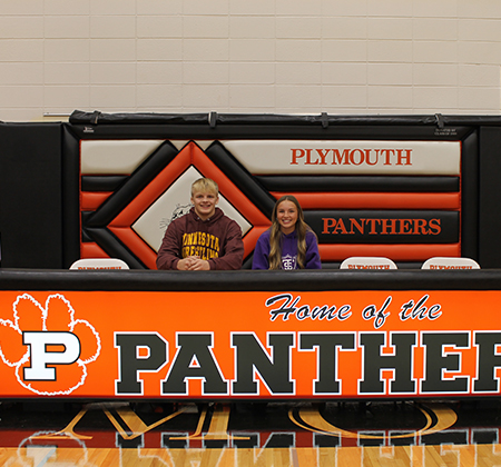 2 athletes at signing table