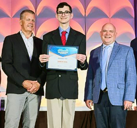 student with certificate and presenters