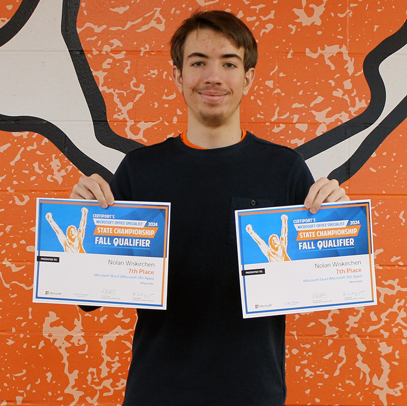 student holding 2 certificates
