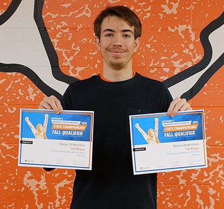student holding 2 certificates