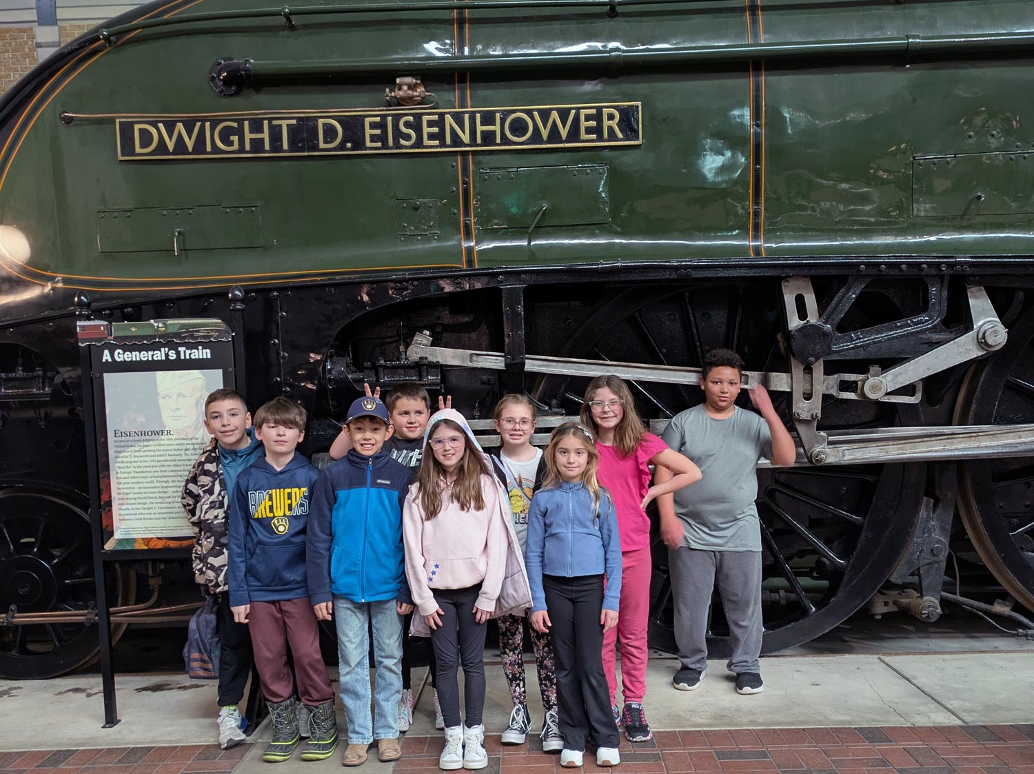 group in front of locomotive