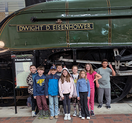 group photo in front of locomotive