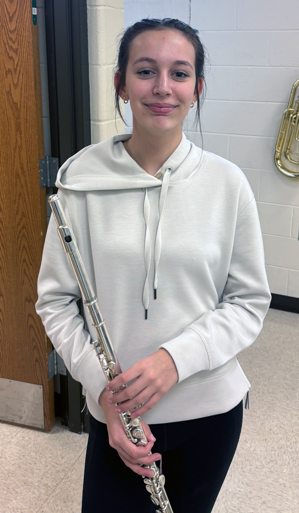 student holding flute