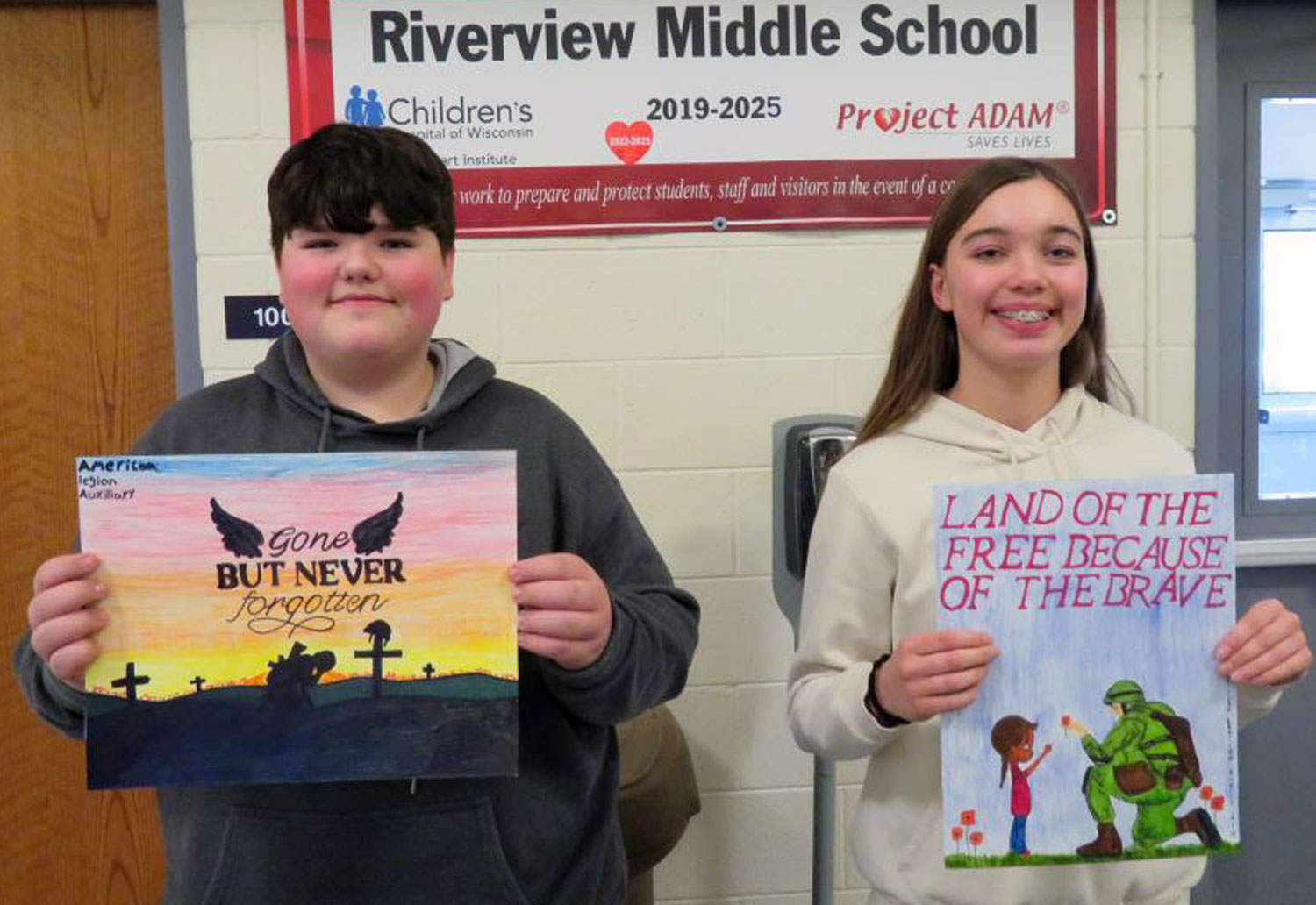 2 students holding their posters