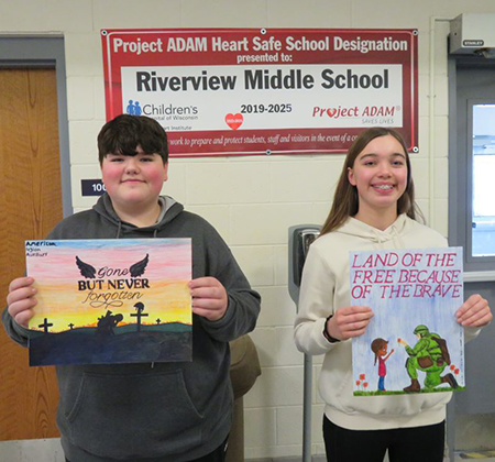 2 students holding posters