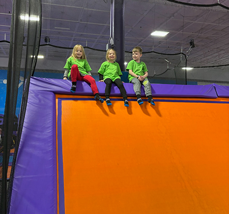 3 students atop climbing structure