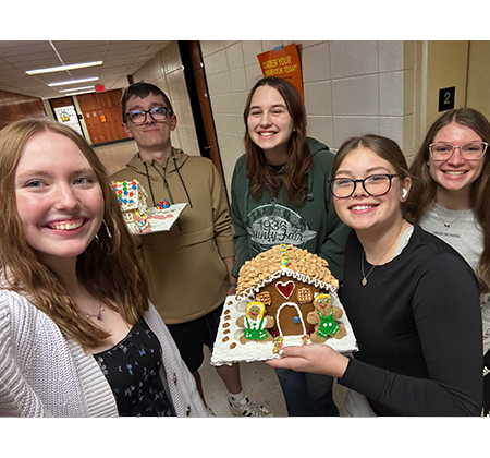 5 students with gingerbread house