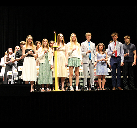 inductees holding candles