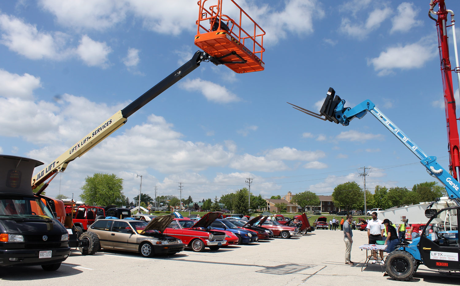 People looking at vehicles