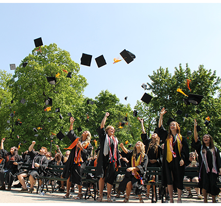 grads tossing caps in air