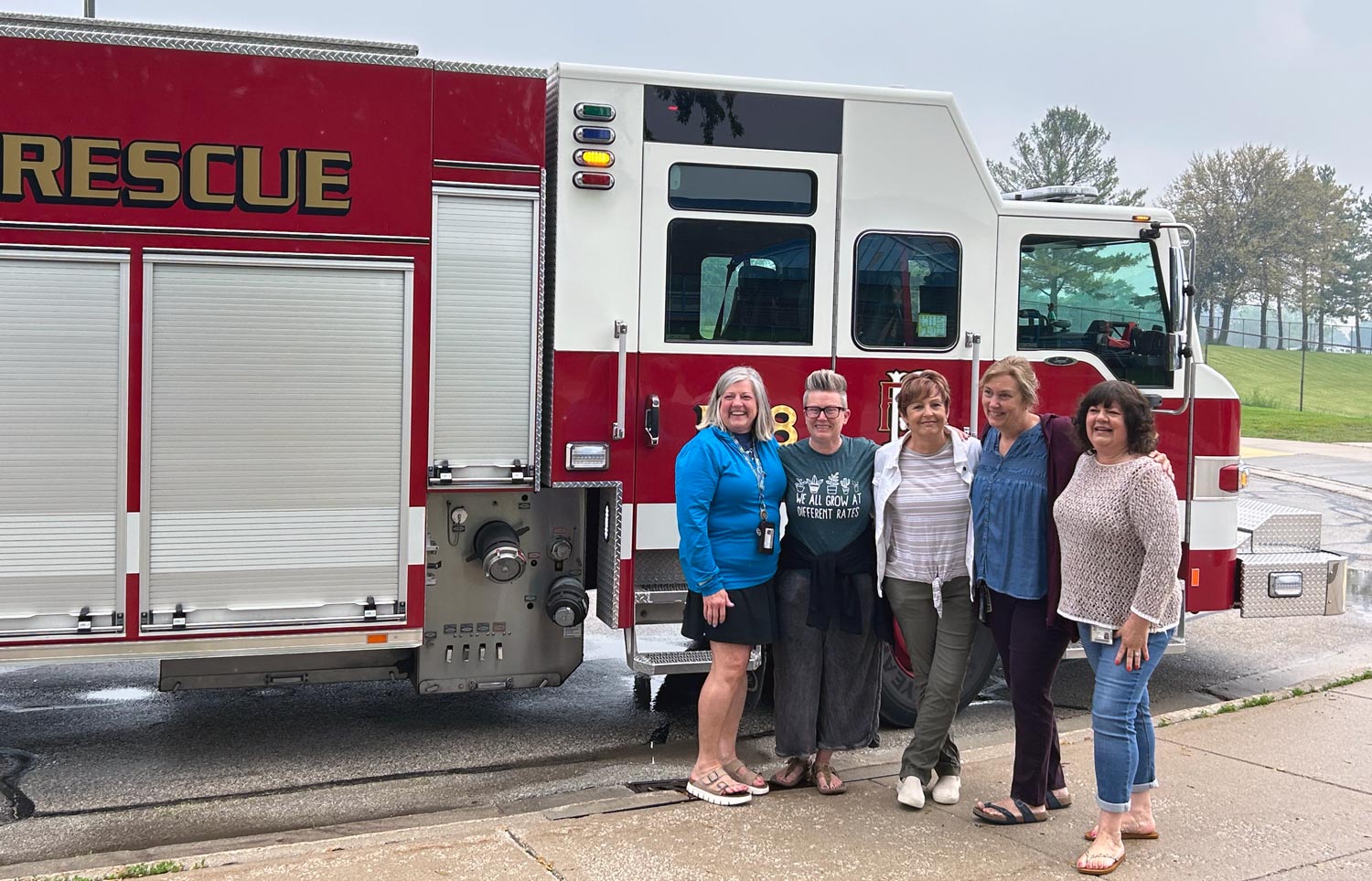 five people next to fire truck