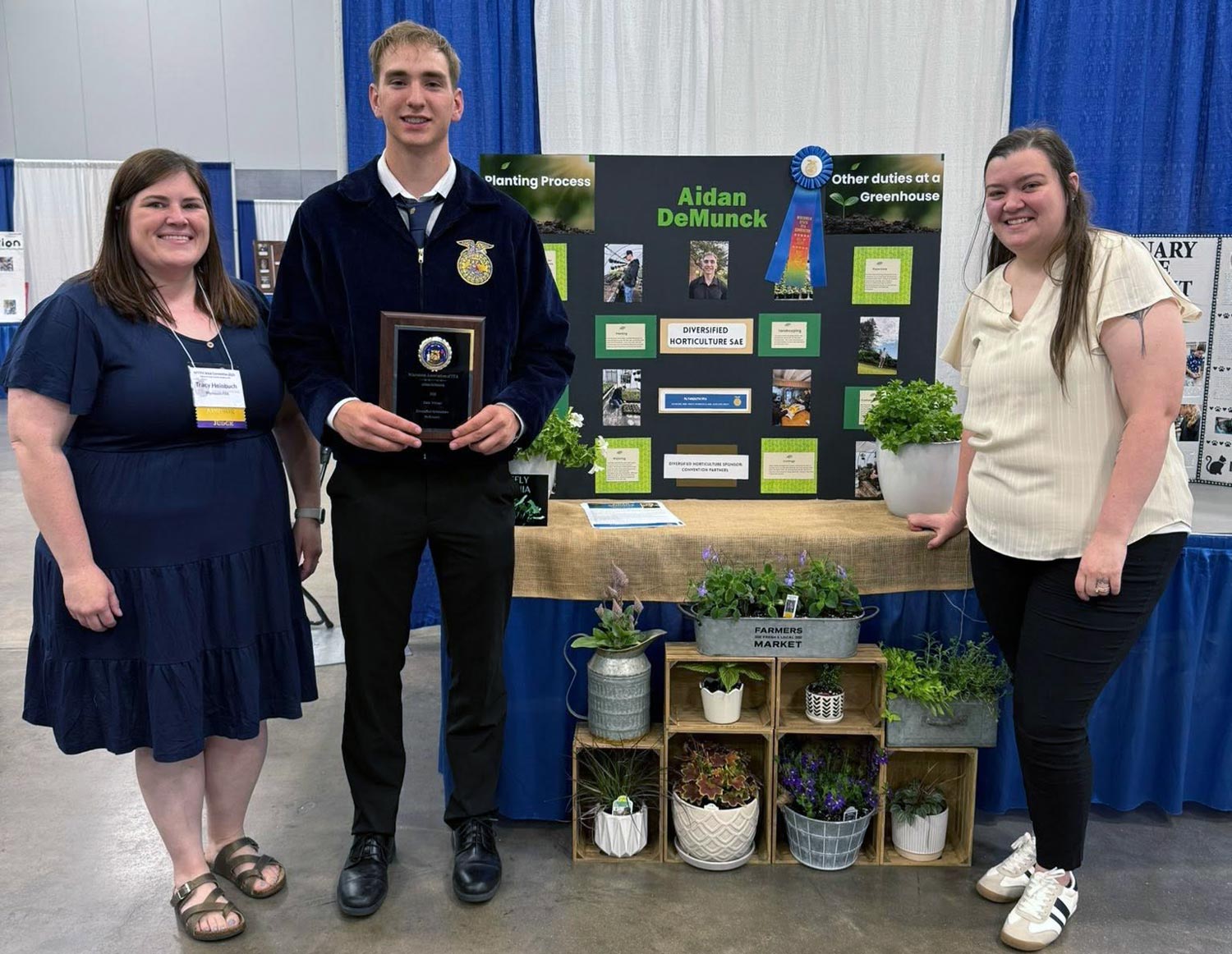 student with advisers and display