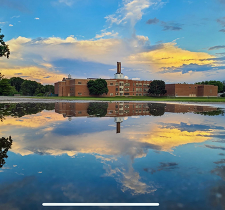 Riverview reflected in puddle