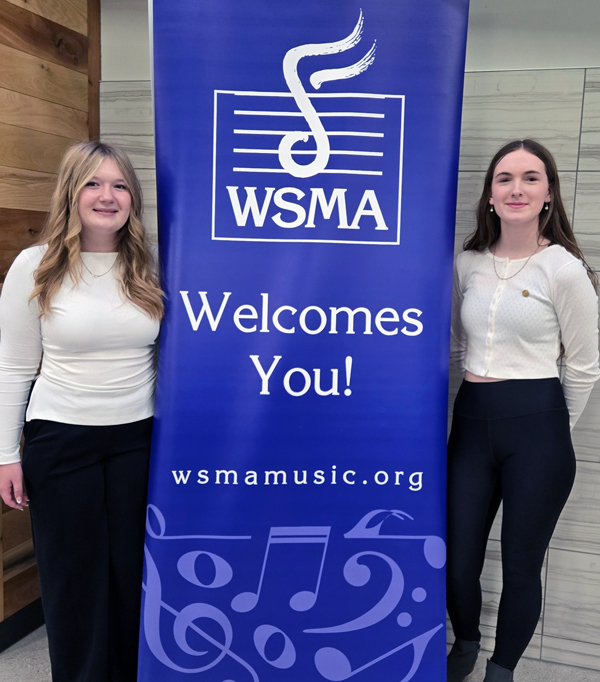 2 students with WSMA banner