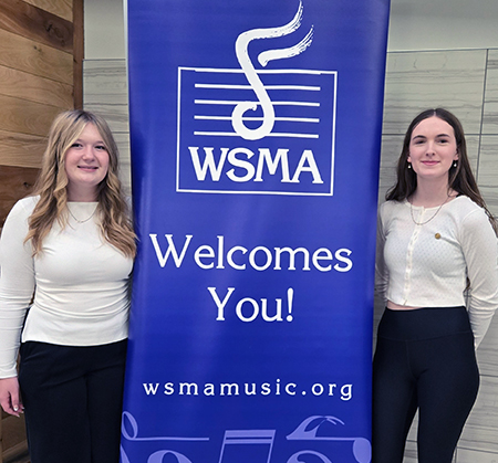 2 students with WSMA banner