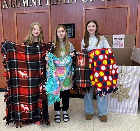 3 students with blankets