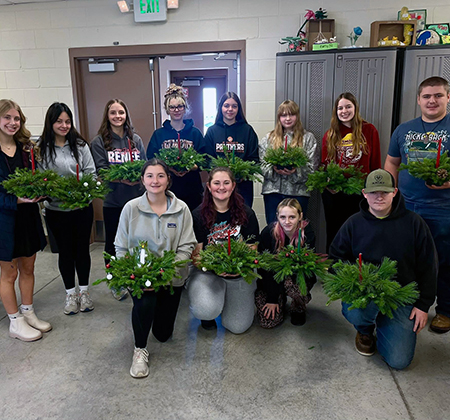 student with evergreen decor