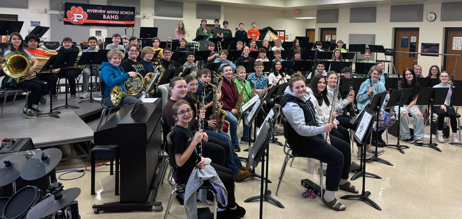 Students with instruments in Band Room