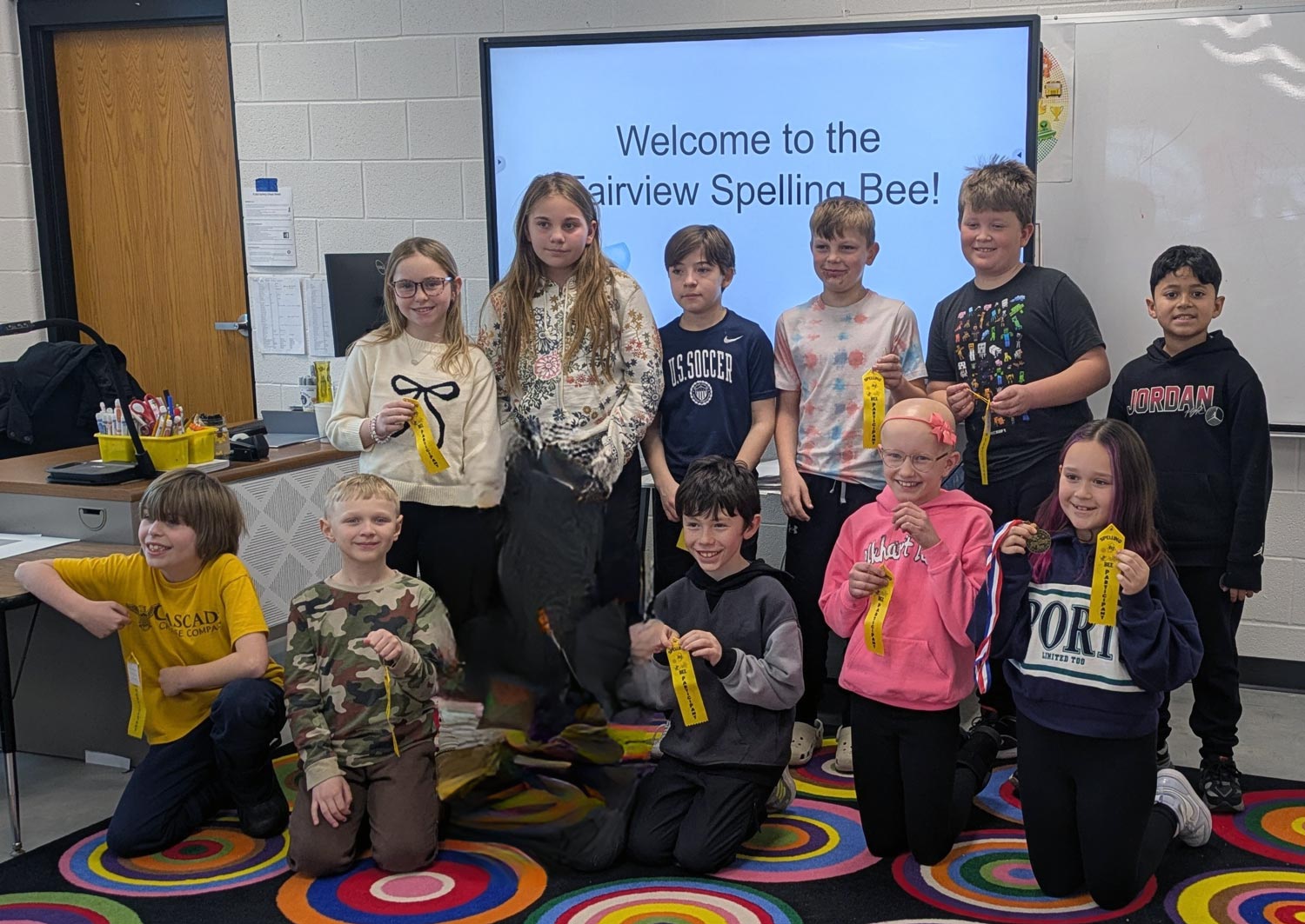 Fairview  Spelling Bee participants holding yellow ribbons in the Fairview Library