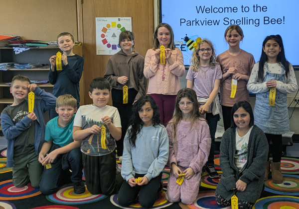 Parkview Spelling Bee participants holding yellow ribbons in the Parkview Library