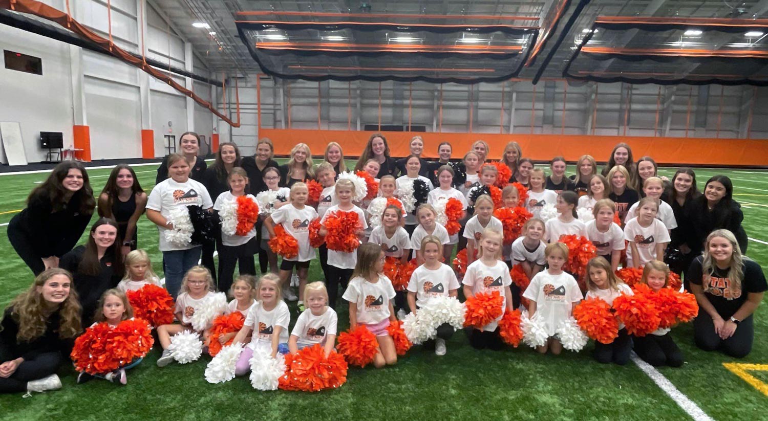 Dance Team members surrounding participants with pom pons