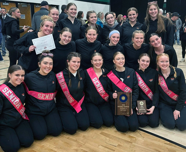 19 dancers posing with wooden plaques and certificate
