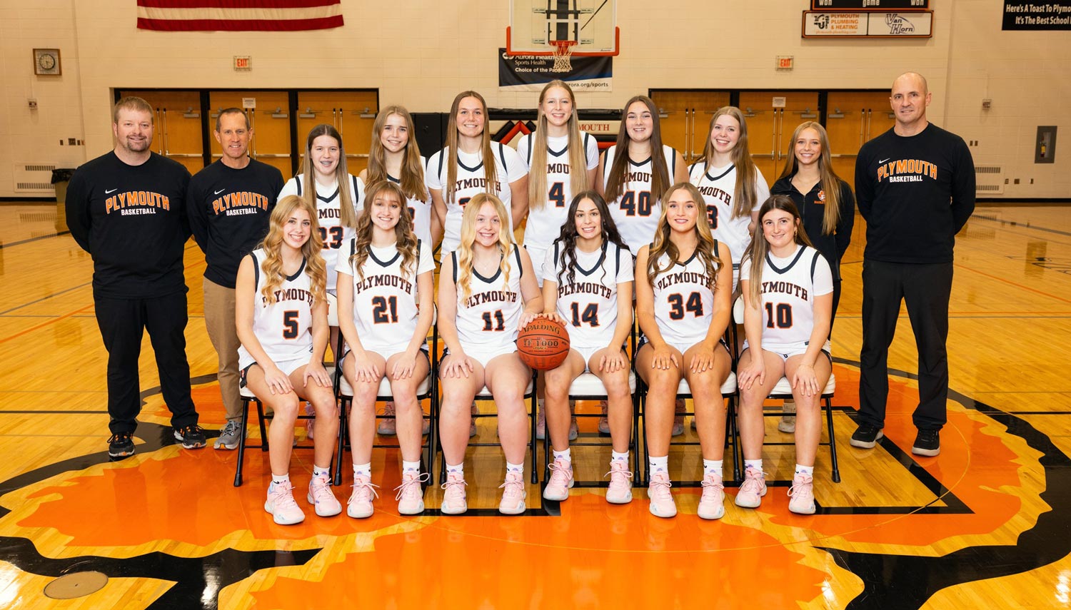 team photo arranged in two rows at center court of the PHS Gym