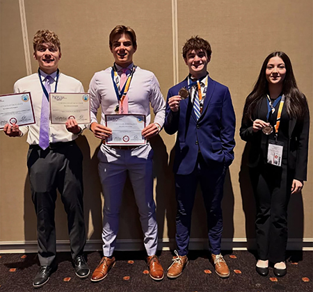 4 students wearing medals