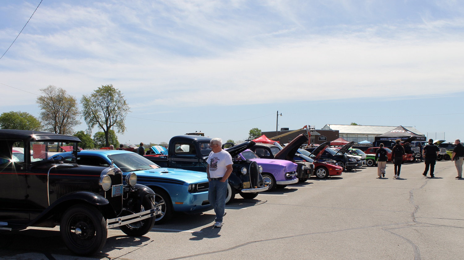 People looking at vehicles