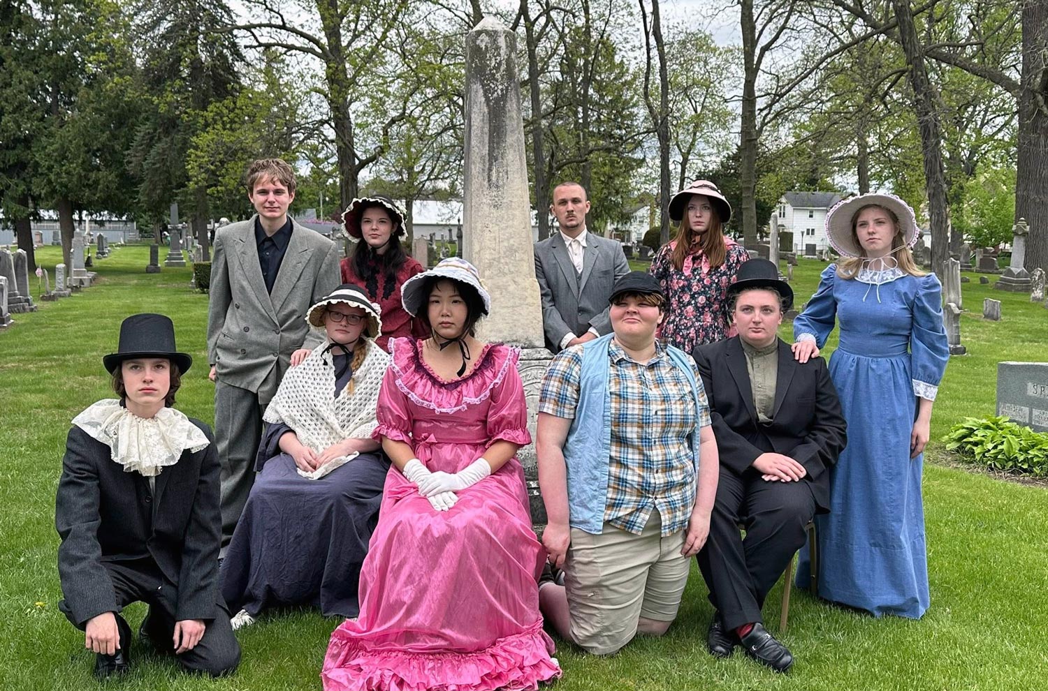 Students in period costume at cemetery