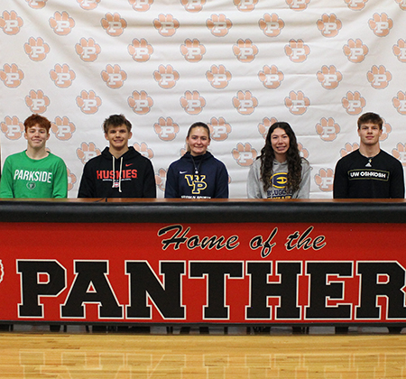 5 athletes behind signing table