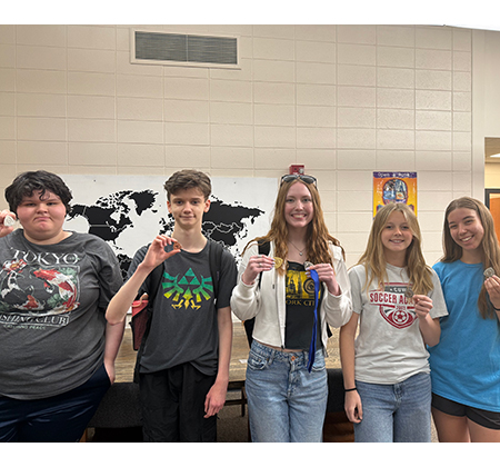 5 students holding medals