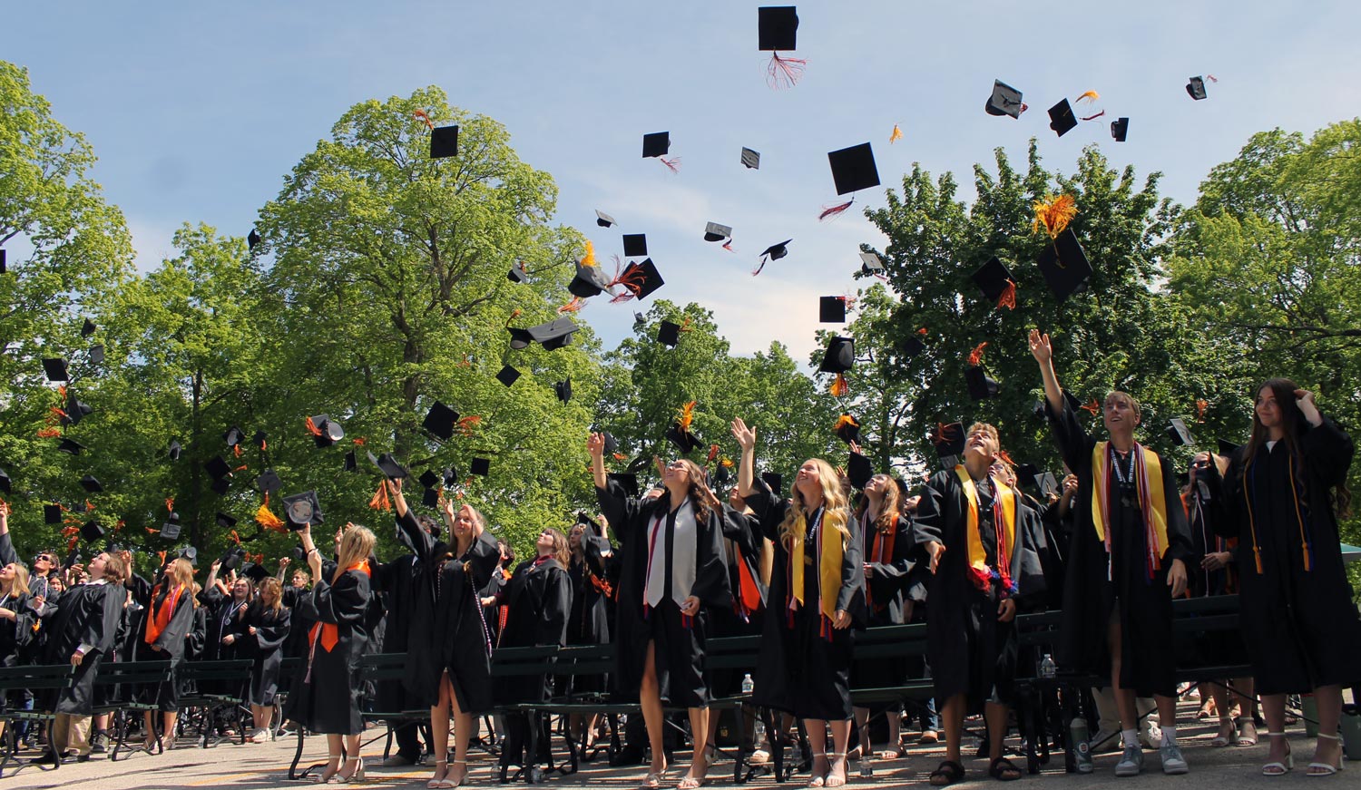 graduates  tossing caps in the air