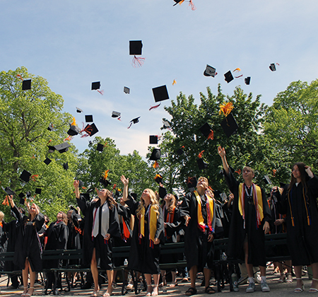 graduates tossing their caps