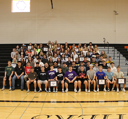 group photo of seniors with signed banners