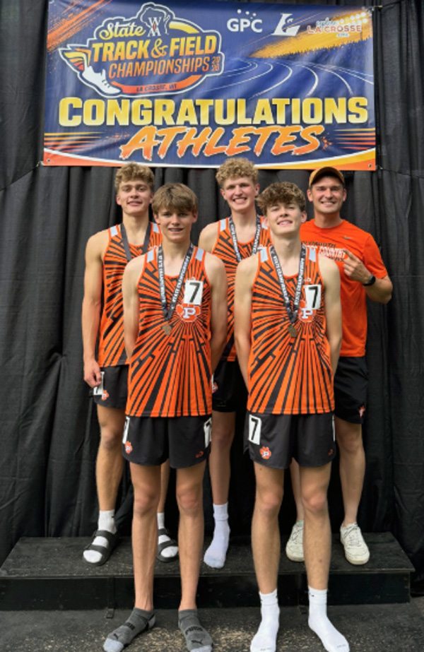 relay team under Congratulations Athletes banner