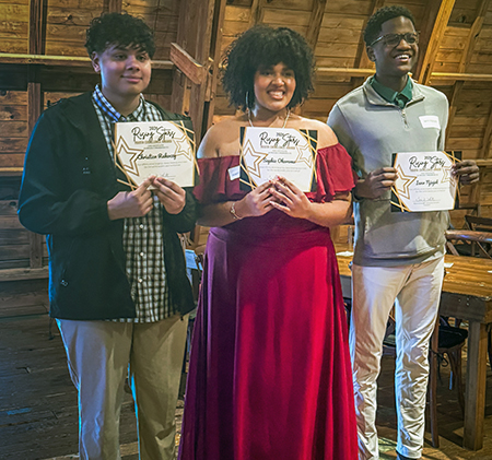 3 students holding certificates