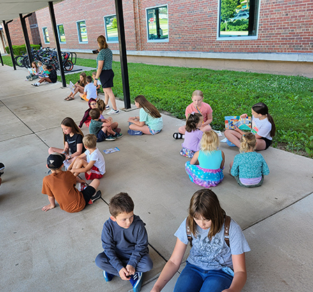 students reading outside