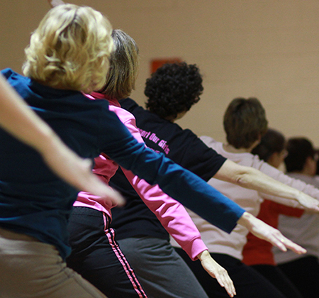 people exercising with arms outstretched