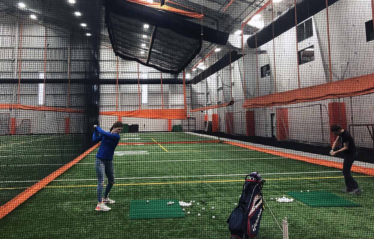 people golfing in multipurpose facility