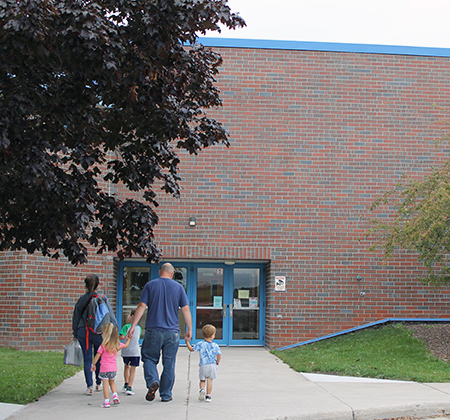 family walking into Horizon