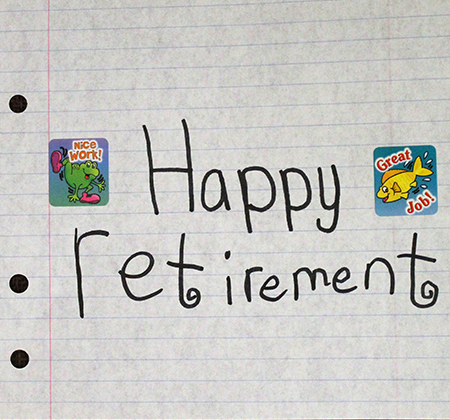 words happy retirement written on notebook paper