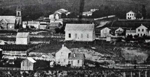 school on hill, surrounded by other buildings